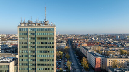 Fototapeta premium Aerial View of Modern Office Tower and Urban District in Krakow With Rooftops Street and Autumn Cityscape