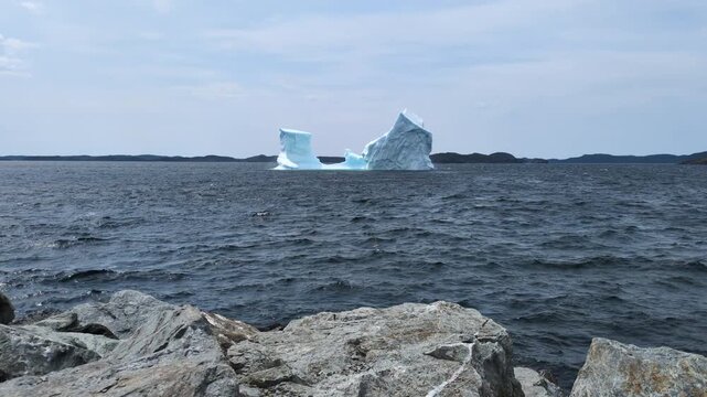 A large iceberg floating and melting in Gillot Cove at Twillingate (Newfoundland, Canada)