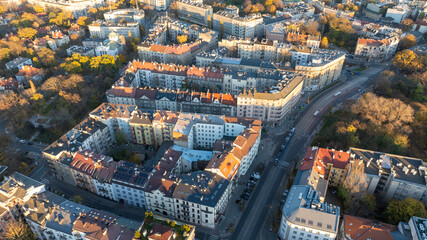 Aerial View of Residential Apartment Blocks and Curving Streets in Krakow During Autumn With Colorful Rooftops and Urban Greenery
