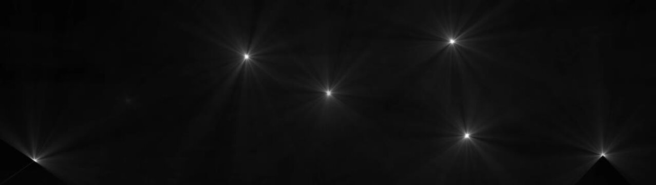 Abstract white light flares and beams emanating from points on a dark background image photo