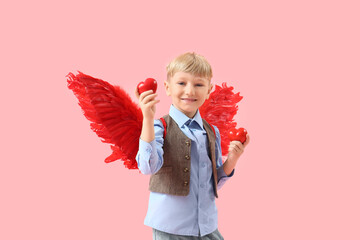 Obraz premium Cute little happy boy in cupid wings with hearts on pink background. Valentine's Day celebration
