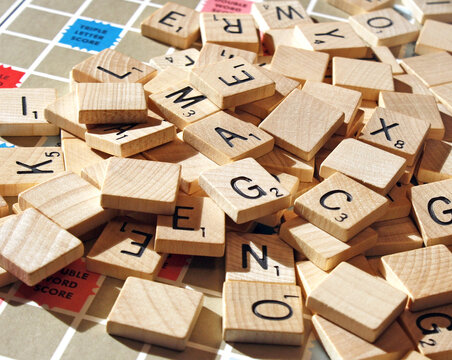 Vintage wooden Scrabble game tiles spread out on the game board.  Photo taken in Ontario Canada January 31, 2026