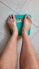 Barefoot Person Weighing on Analog Bathroom Scale