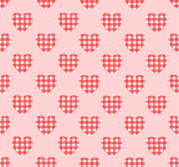 Seamless pattern of red gingham hearts on a pink background.