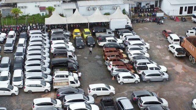 Aerial view of cars parked in a row for auction, there are various types of cars