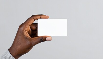 Fototapeta premium Hand holding blank business card against neutral background