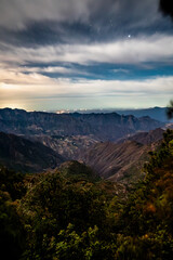 Village nestled among mountains at night, Huizar village between the mountains and Mazatlan in the background, in Mexiquillo, Pueblo Nuevo Durango