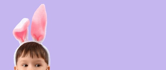 Fototapeta premium Cute little boy wearing Easter bunny ears on lilac background with space for text