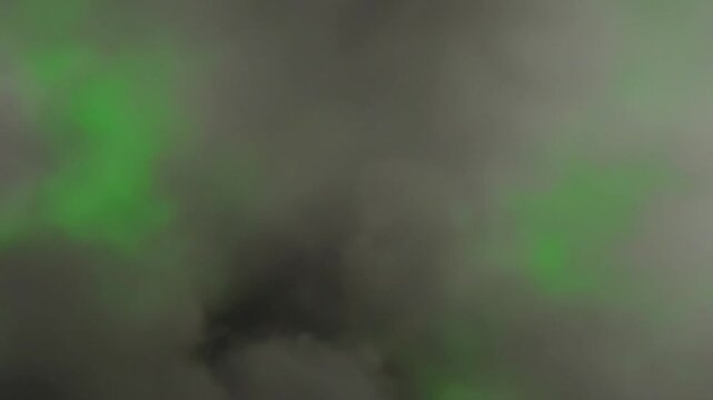 Dense smoke burst VFX element isolated on chroma green background for keying