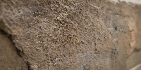 Naklejka premium Natural Rough Stone Wall Texture with Neutral Earth Tones