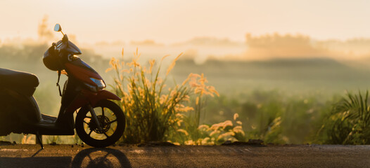 Moto scooter on a country road in fog at sunrise, concept of independent travel, road trip adventure and exploration of new places. High quality photo © Vladimir Razgulyaev