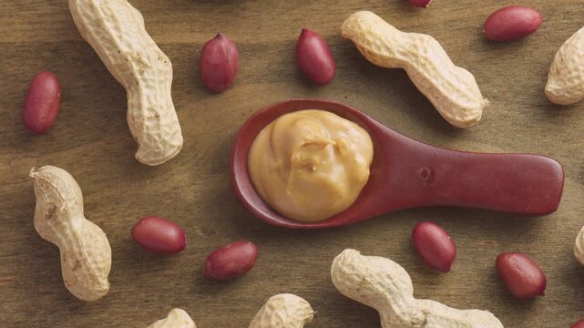 Wooden spoon of tasty peanut butter. Macro shot