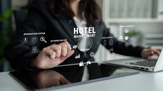 Business professional analyzing hotel management data with modern technology and digital interface for effective decision-making and operational efficiency Quark.