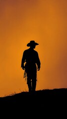 Silhouette of Cowboy Standing on Hill at Sunset.