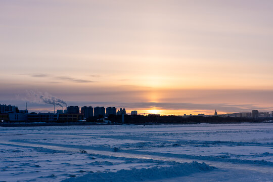 Winter sunset over Heihe. View from across the Amur River at dusk.