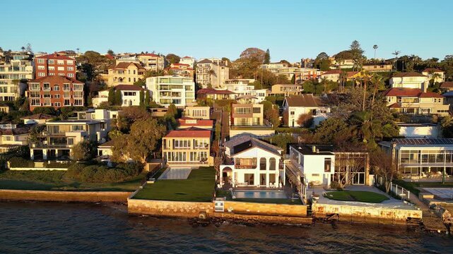 Sydney, Australia: Aerial drone footage of waterfront luxury villas and apartment towers in Rose Bay in Sydney, Australia. Taken at sunset