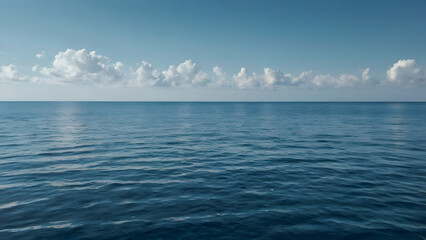 Obraz premium Endless Horizon: Capturing the vastness and serenity of the open sea under a bright, cloud-dotted sky, a perfect blend of water and air.