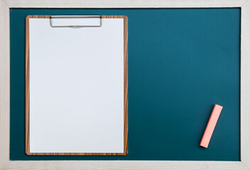 Blank white paper on wooden clipboard on black board background, education concept