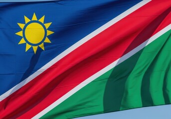 Fototapeta premium Namibia Flag Waving Against Blue Sky