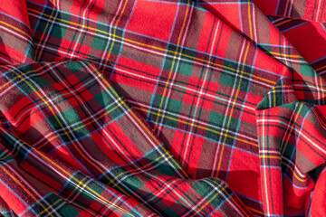 Vibrant red tartan pattern fabric with green and yellow stripes