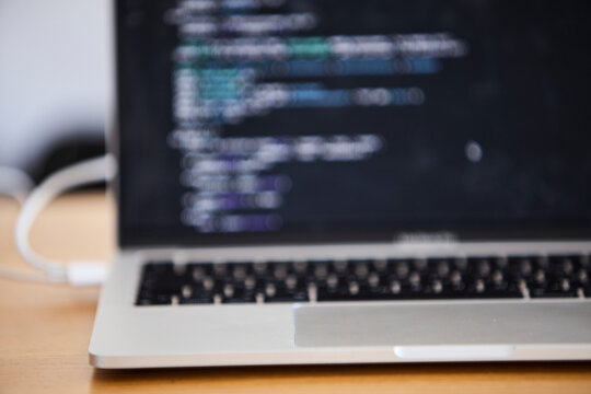Laptop with programming code open on screen