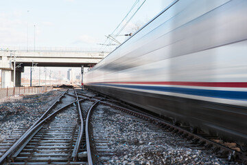 Obraz premium High speed train runs on rail tracks - Train in motion