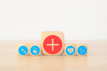 Wooden toy stack with medical health care icons for safety insurance for sick illness wellbeing protection plan or retirement healthy therapy treatment or health checkup