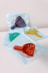 Sterile dental impression trays sealed in medical packages with different colors
