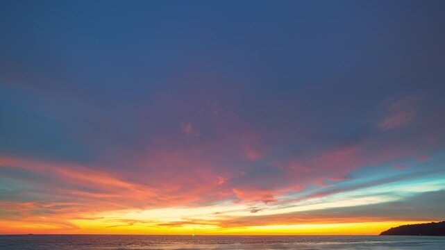 Dramatic Cloudscape of Sunset Radiance Above Karon beach. A fiery sunset sky glows with deep reds and golden hues, painting the horizon with warmth and serenity as twilight embraces the evening.