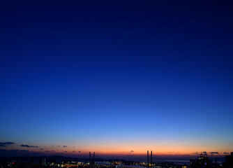 City skyline at blue hour with cable-stayed bridges.
