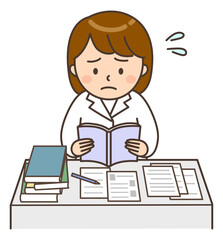 困った顔で本を読んでいるデスクワーク中の女性医師