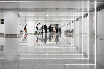 Naklejka premium Pedestrians walking in a modern bright corridor