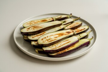 Grilled eggplant slices on white plate