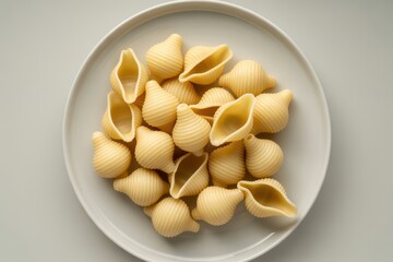 Conchiglie pasta shells on white plate ridged pasta