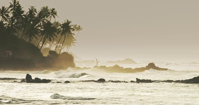 Dramatic Ocean Waves and Coastal Silhouettes at Dusk