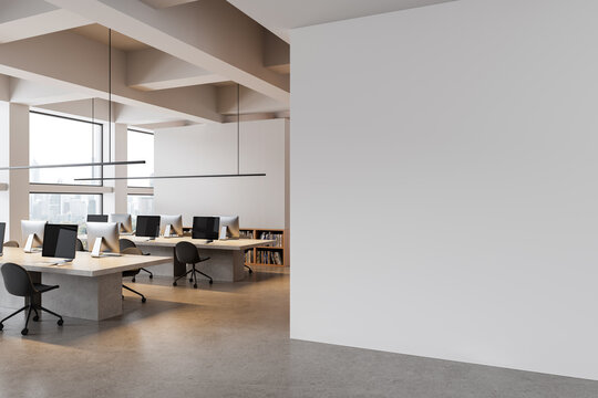 Modern open office interior with blank white wall for poster mockup or design template display, featuring clean workspace layout and bright view. 3D Rendering