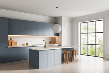 Modern minimalist kitchen interior with blue cabinets, large island, and pendant lighting in bright...