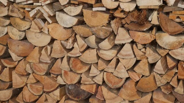Neatly organized stack of dry seasoned firewood logs ready for fireplace heating and winter fuel supply