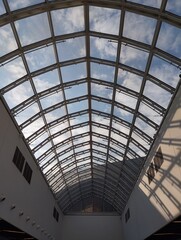 Obraz premium symmetrical spacious roof with windows with blue sky and white cloud behind it sunlight and sun