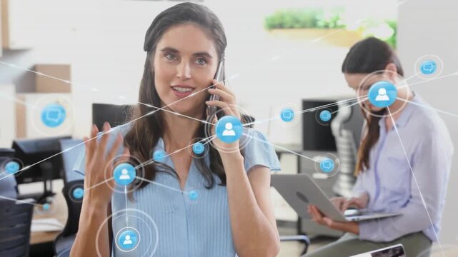 Animation of connected icons over confused caucasian woman talking on smartphone in office