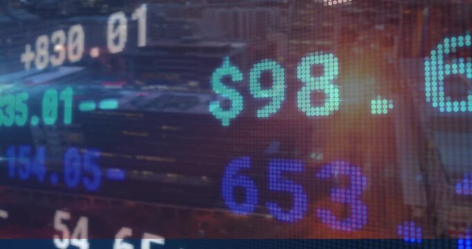 Cityscape at sunset with animation of digital stock market numbers overlaying view