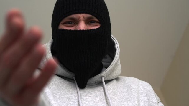 A gangster in a black mask.
A bandit with a covered face.