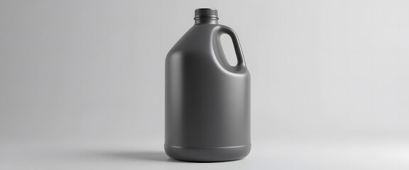 Obraz premium A single dark gray plastic jug with a handle and black cap on a plain background. 1 gallon jug