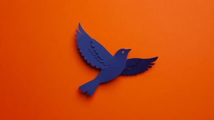 Obraz premium One paper black crow with raised wings in the upper right corner on an orange background with space for text.