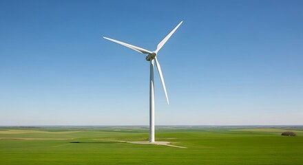 Fototapeta premium Wind Turbine in Green Field Under Blue Sky
