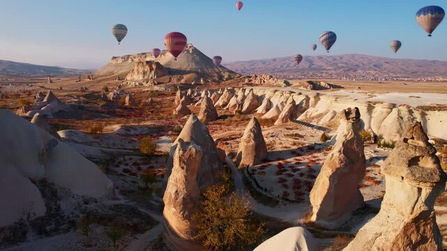 Aerial view landscape of hot air balloons over love valley, Cappadocia Turkey at sunrise.
