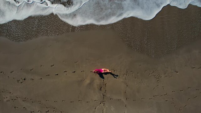 Aerial travel scene woman in pink swimsuit relaxed on sandy beach Patara Antalya Turkey, concept freedom life style.