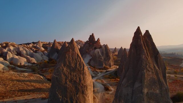 Aerial view landscape journey over Cappadocia Turkey majestic rock formations rock formations from tuff at golden hour.