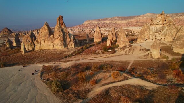 Aerial view landscape journey over Cappadocia Turkey majestic rock formations rock formations from tuff at golden hour.