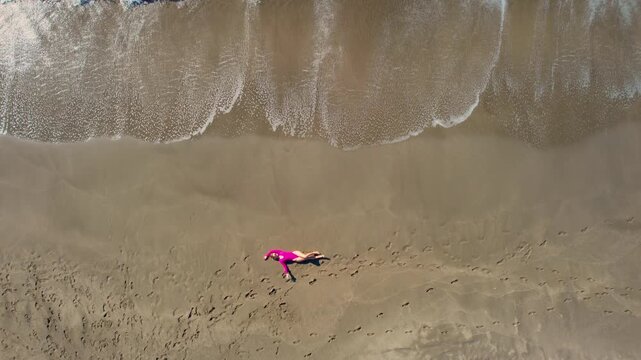 Aerial travel scene woman in pink swimsuit relaxed on sandy beach Patara Antalya Turkey.
